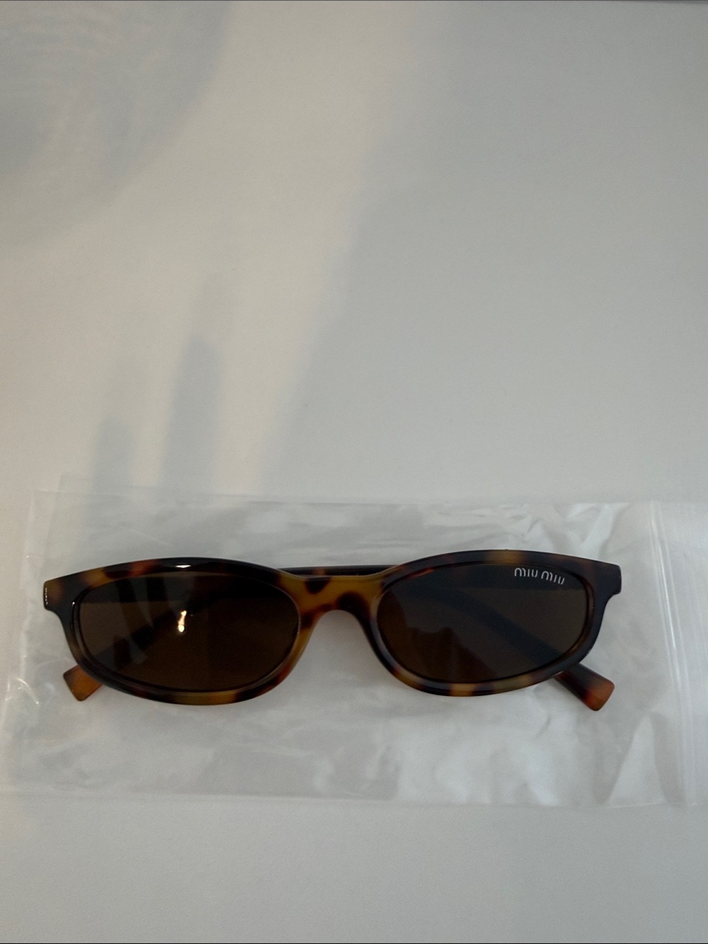 Miu Miu Tortoiseshell Oval Sunglasses with Dark Brown Lenses